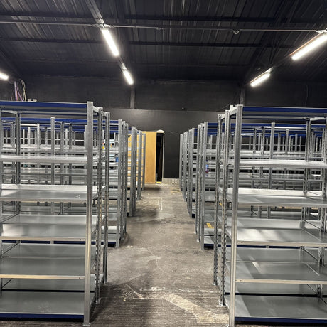 Rows of RackZone Easy Rack Galvanised Shelving 300mm in a spacious warehouse.