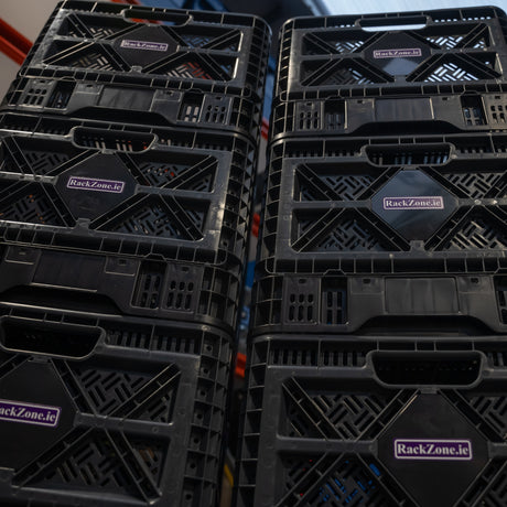 Six RackZone Foldable Crates 59L stacked in a storage area.