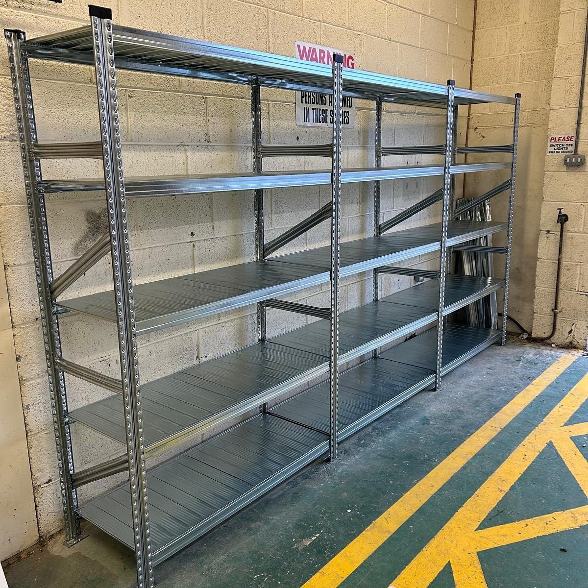 RackZone Galvanised Shelving 400mm Extender units against a beige brick wall.