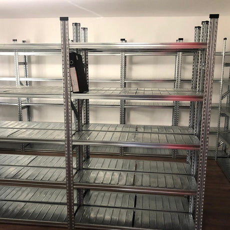 Nearly empty RackZone Galvanised Shelving 600mm with one black binder.