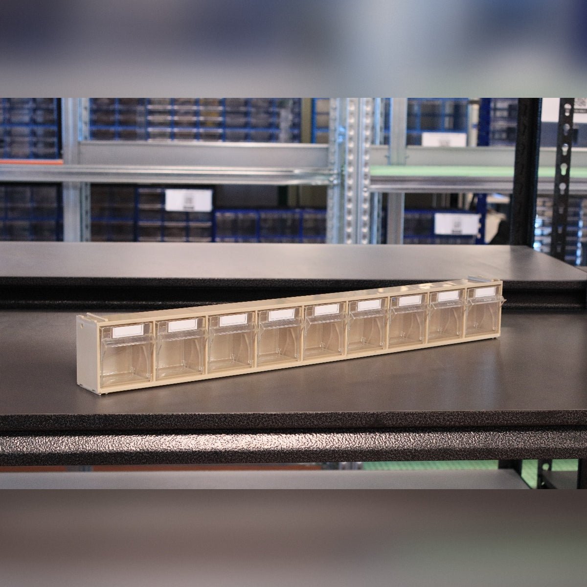 A beige RackZone 9-tilt bin storage sits on a black shelf.