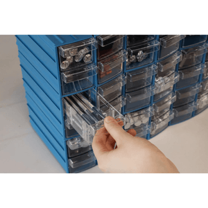 Hand pulls open a RackZone Pull Out Drawer (96/box) from storage organizer.