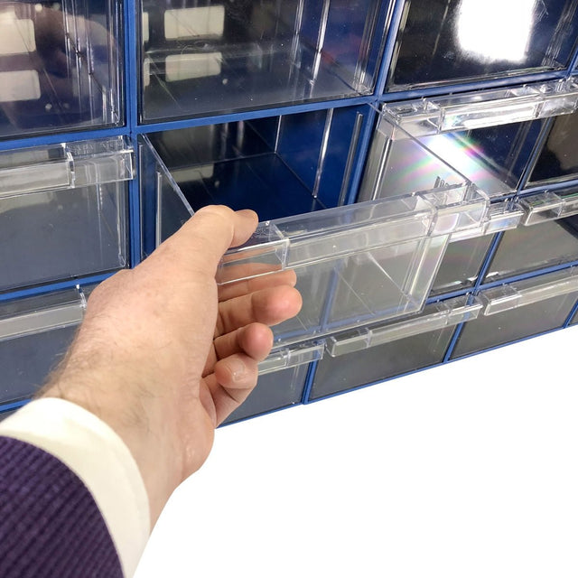 A hand pulls out a RackZone Plastic Drawer 24 Box Blue from a wall organizer.