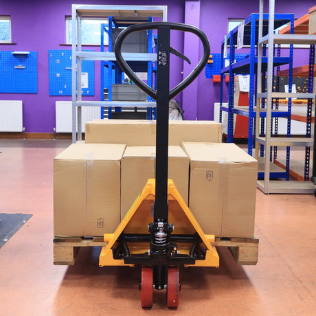 RackZone Pallet Truck 2500kg with PU wheels transports boxes in warehouses.