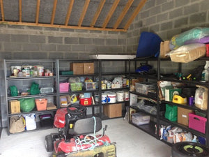 RackZone Rivet Shelving and storage boxes with a lawnmower in front.