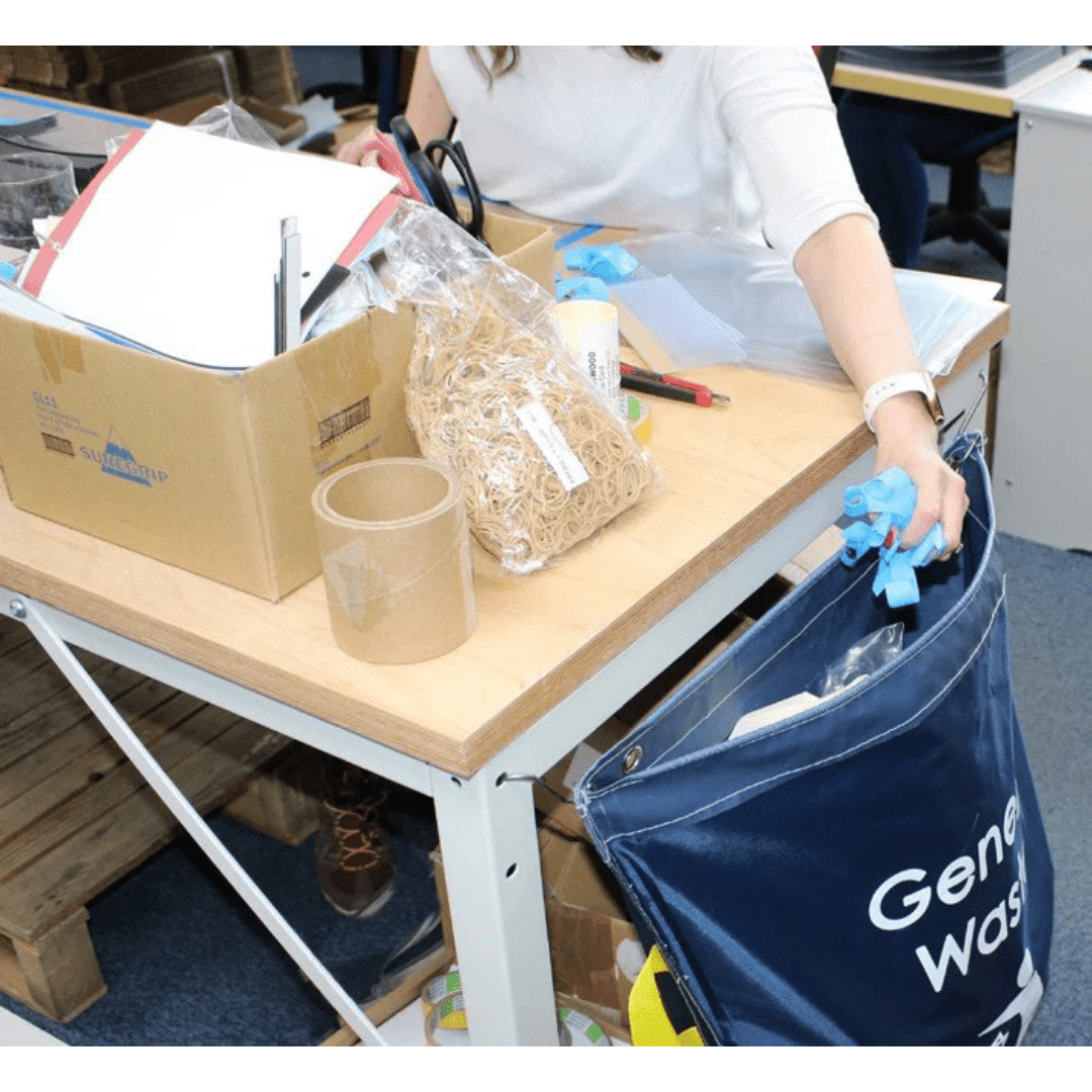 Person disposing of items into a RackZone Racksack Mini General Waste (Blue).