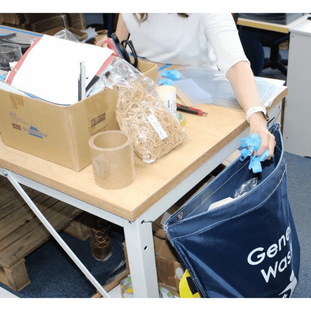 Person disposing of items into a RackZone Racksack Mini General Waste (Blue).