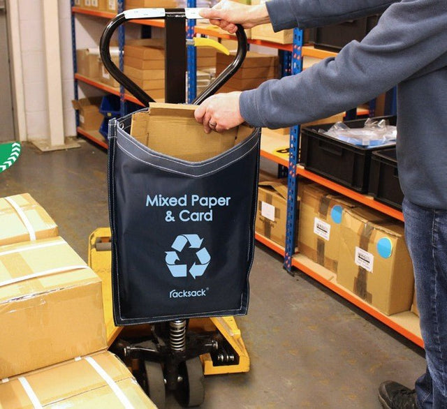 A person uses a RackZone Racksack Nano Mixed Recycling - Blue in a warehouse.