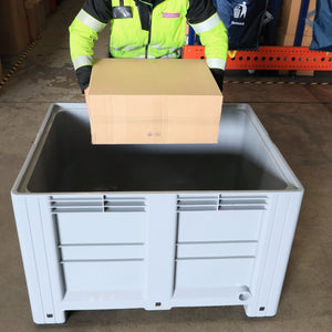 Person placing a cardboard box into a RackZone Pallet Box 1200x1000x760mm.