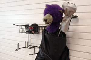 The RackZone Slatwall Golf Rack stores clubs with purple bear, silver headcovers.