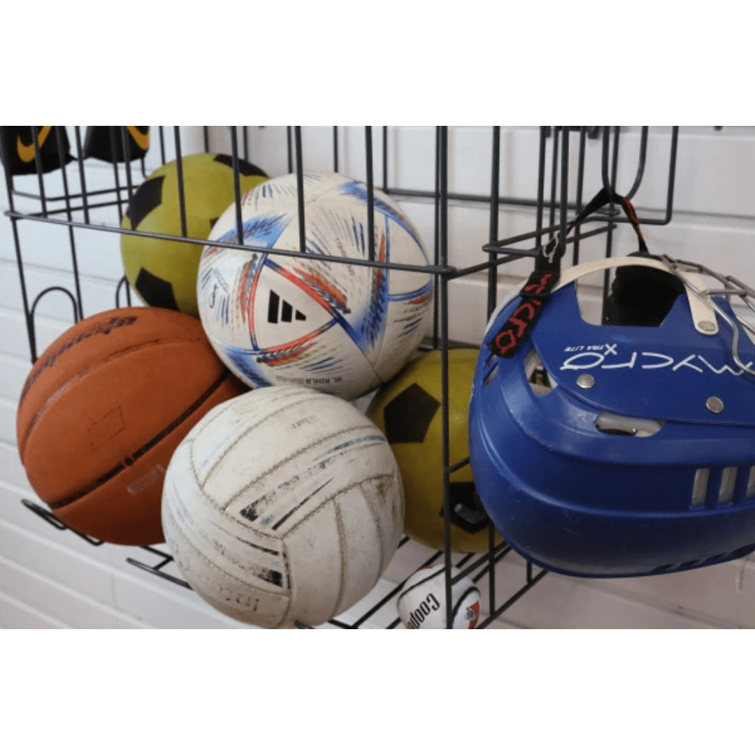 RackZone Slatwall Sports Rack holds balls and a blue helmet.