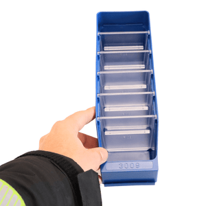 A hand holds a RackZone Standard Shelf Bin ST3009 in blue with dividers.