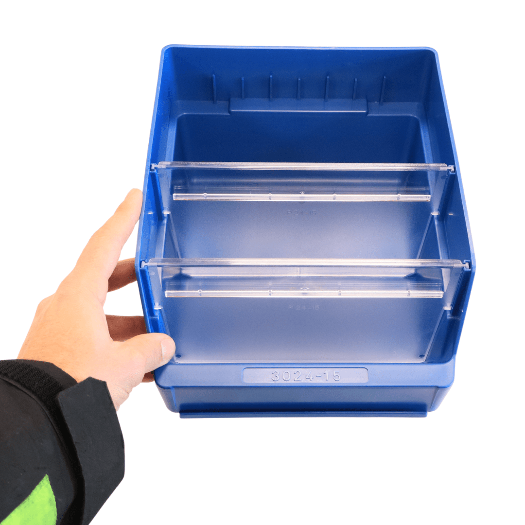 A hand holds a RackZone ST3024-15 blue bin with two clear divider rails inside.