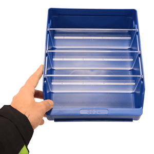 A hand holds a blue RackZone ST3024 shelf bin with three clear dividers.