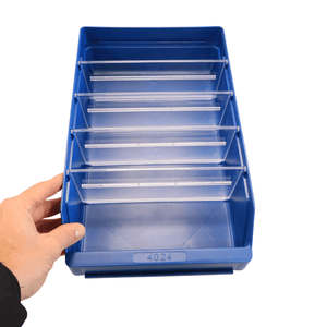 Hand holding a blue RackZone ST4024 shelf bin with five clear dividers.