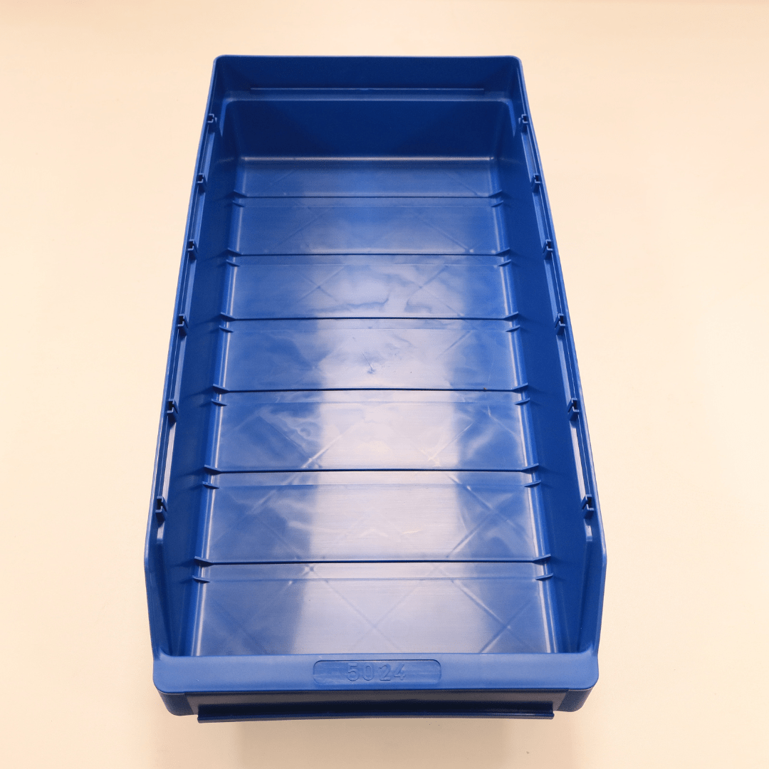 A RackZone Standard Shelf Bin ST5024 blue sits on a light-colored surface.
