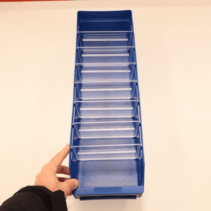 A hand holds a RackZone ST6018 blue shelf bin with eight clear dividers.