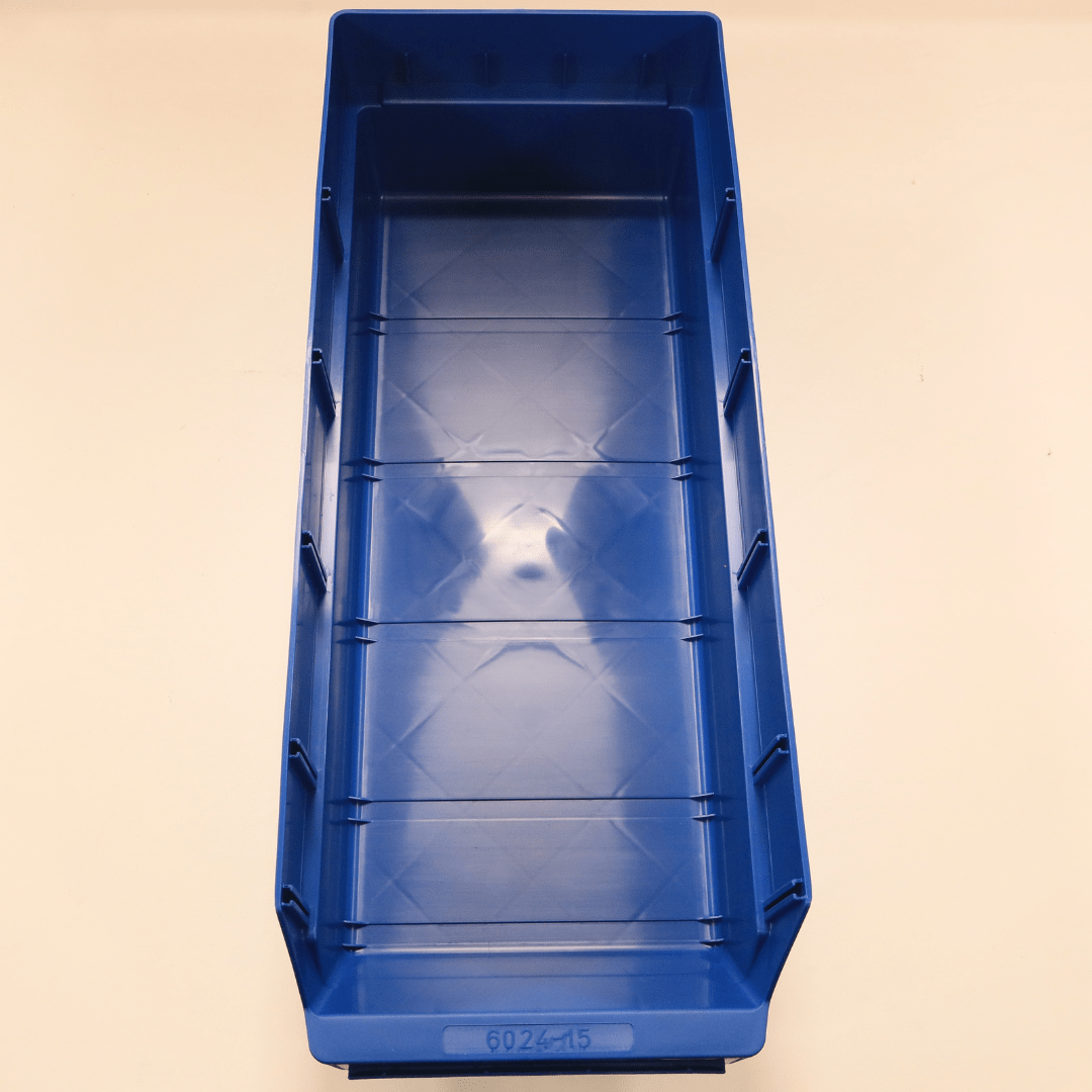 A blue RackZone Standard Shelf Bin ST6024-15 on a beige surface, top view.